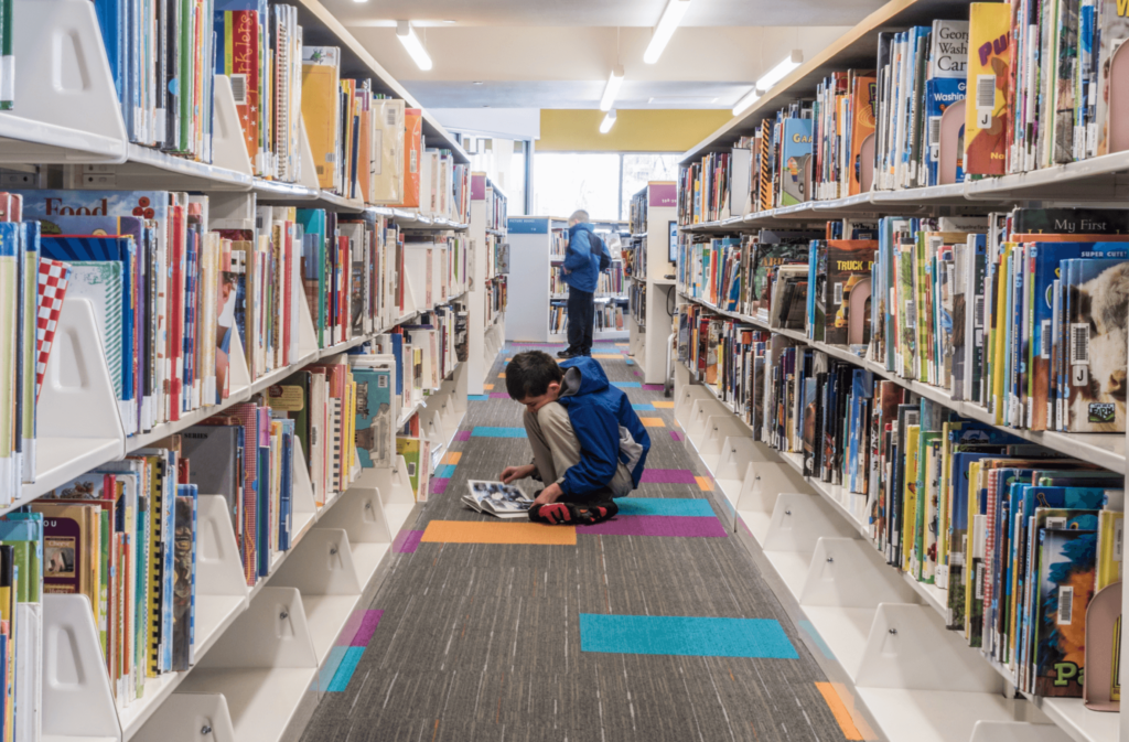 kneeling person in the stacks