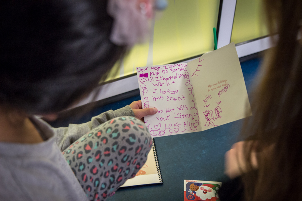 Child holding card with writing